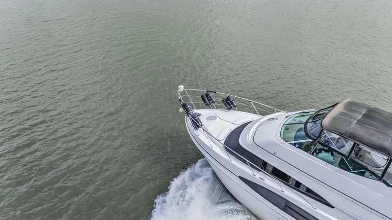 Slide: The Image of Aerial view of 2004 Carver 466 Motor Yacht cruising on open water. - 2