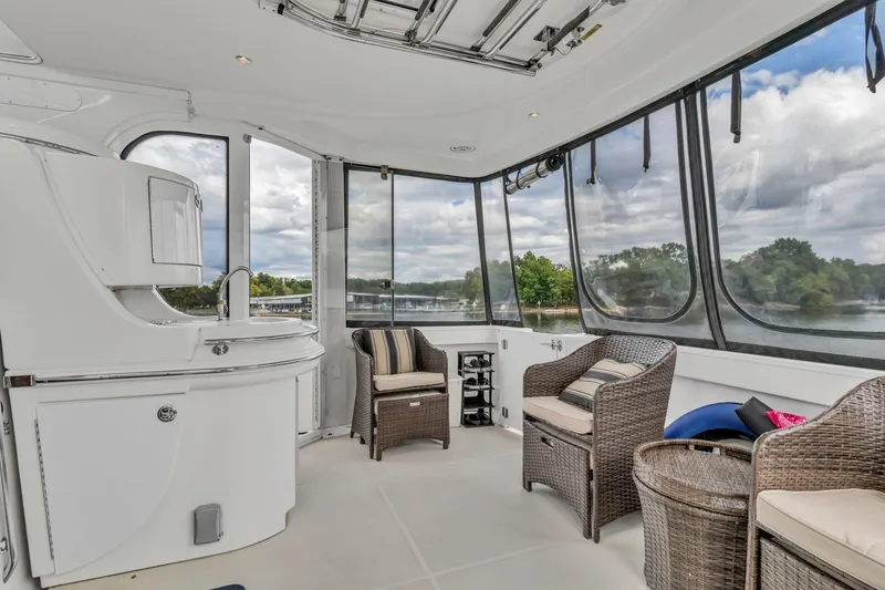 Slide: The Image of Interior of 2004 Carver 466 Motor Yacht with wicker chairs and panoramic windows. - 21