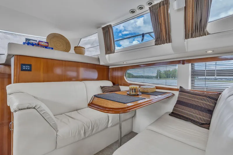 Slide: The Image of Luxurious interior of 2004 Carver 466 Motor Yacht with elegant seating and dining area. - 23