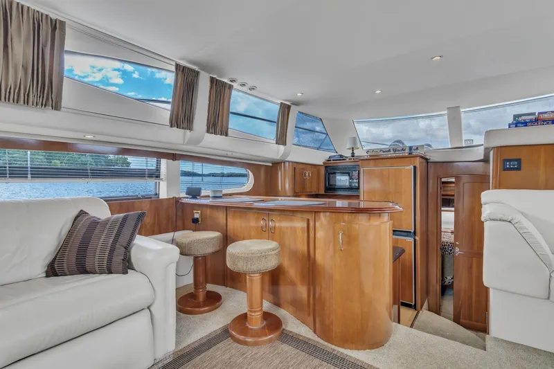 Slide: The Image of Luxurious interior of 2004 Carver 466 Motor Yacht with elegant wood finishes and comfortable seating. - 27