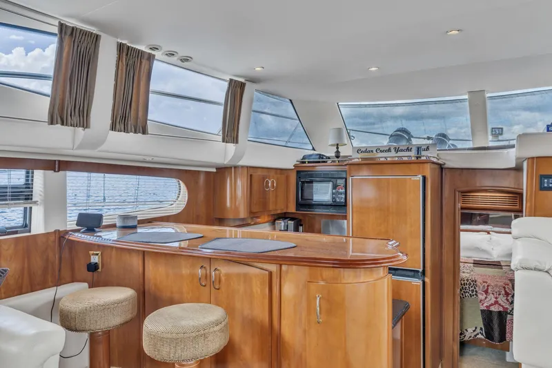 Slide: The Image of Luxurious interior of 2004 Carver 466 Motor Yacht with elegant wood finishes and modern amenities. - 28