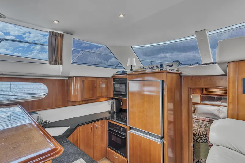 Slide: The Image of Interior of 2004 Carver 466 Motor Yacht with modern kitchen and panoramic windows. - 29