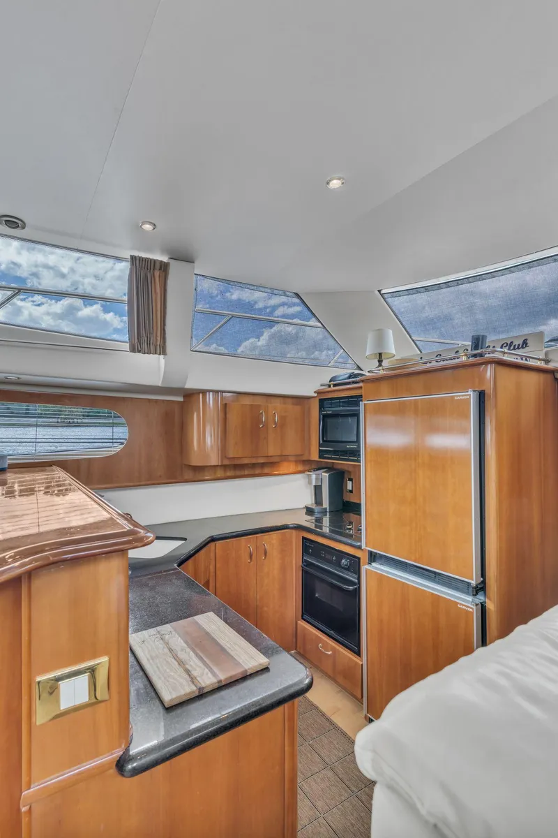 Slide: The Image of Interior of 2004 Carver 466 Motor Yacht with modern kitchen amenities. - 30