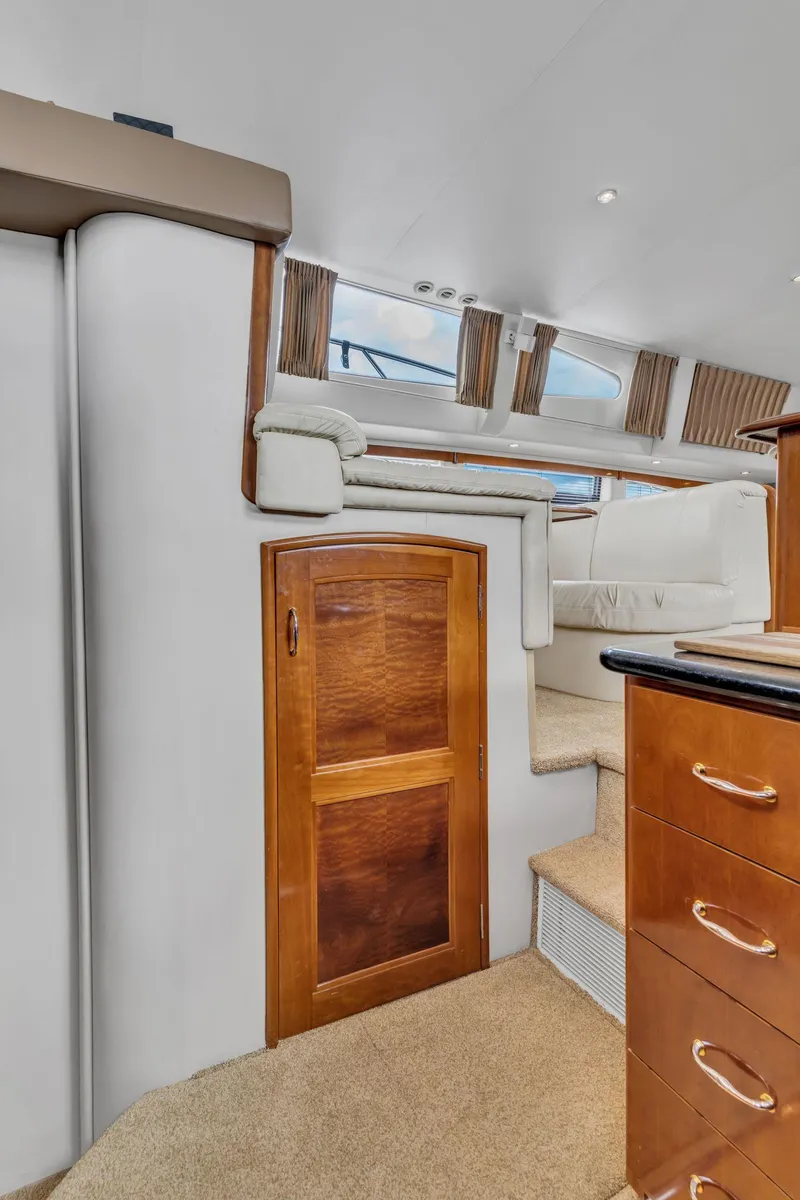 Slide: The Image of Interior of 2004 Carver 466 Motor Yacht with wooden cabinetry and carpeted stairs. - 34