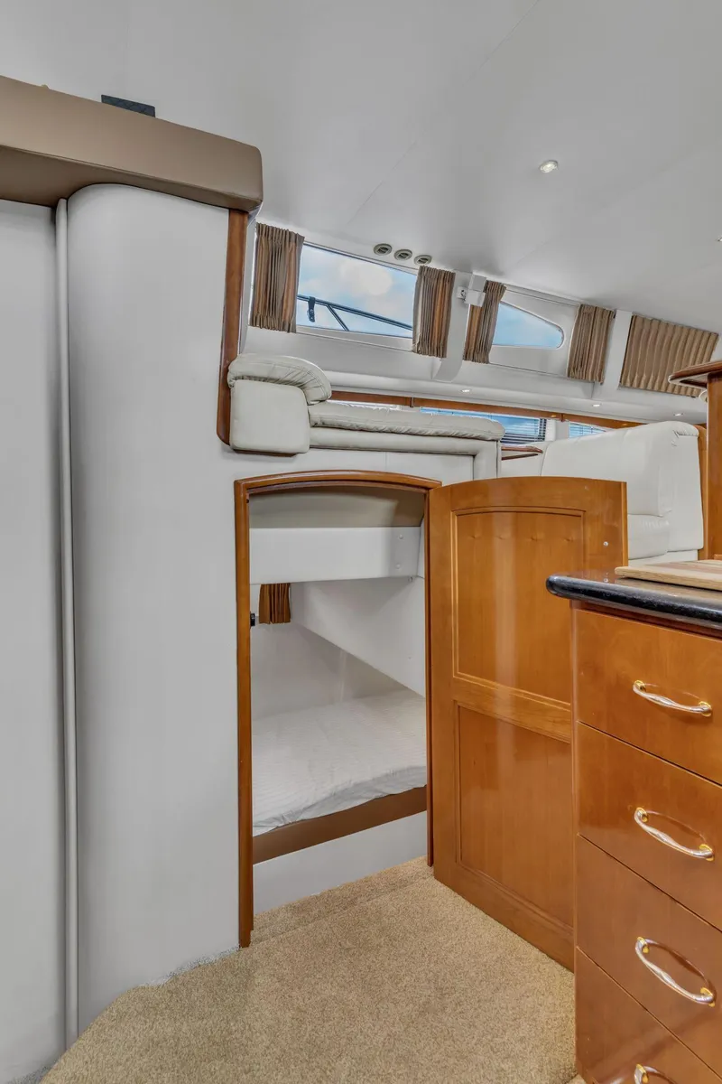 Slide: The Image of Interior of 2004 Carver 466 Motor Yacht with wooden cabinetry and cozy seating area. - 35