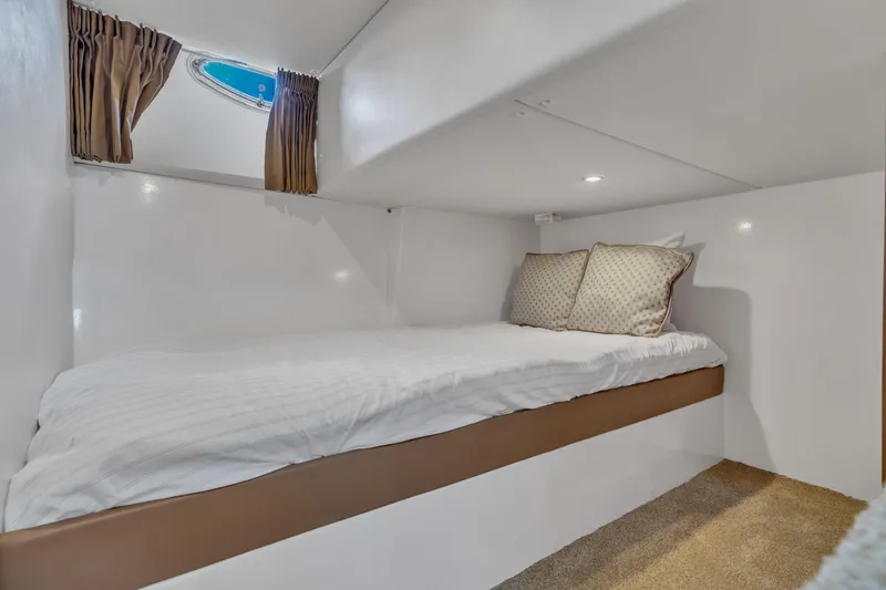 Slide: The Image of Cozy cabin bed in 2004 Carver 466 Motor Yacht with window and pillows. - 36