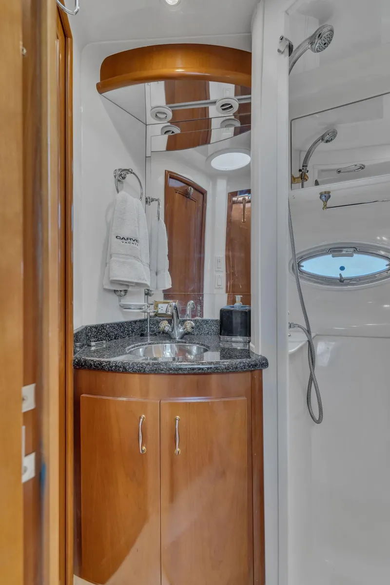Slide: The Image of Luxurious bathroom in 2004 Carver 466 Motor Yacht with modern fixtures and wood cabinetry. - 43