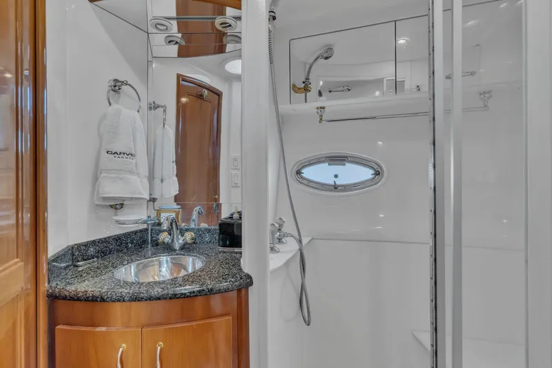 Slide: The Image of Luxurious bathroom in 2004 Carver 466 Motor Yacht with modern fixtures and porthole window. - 44