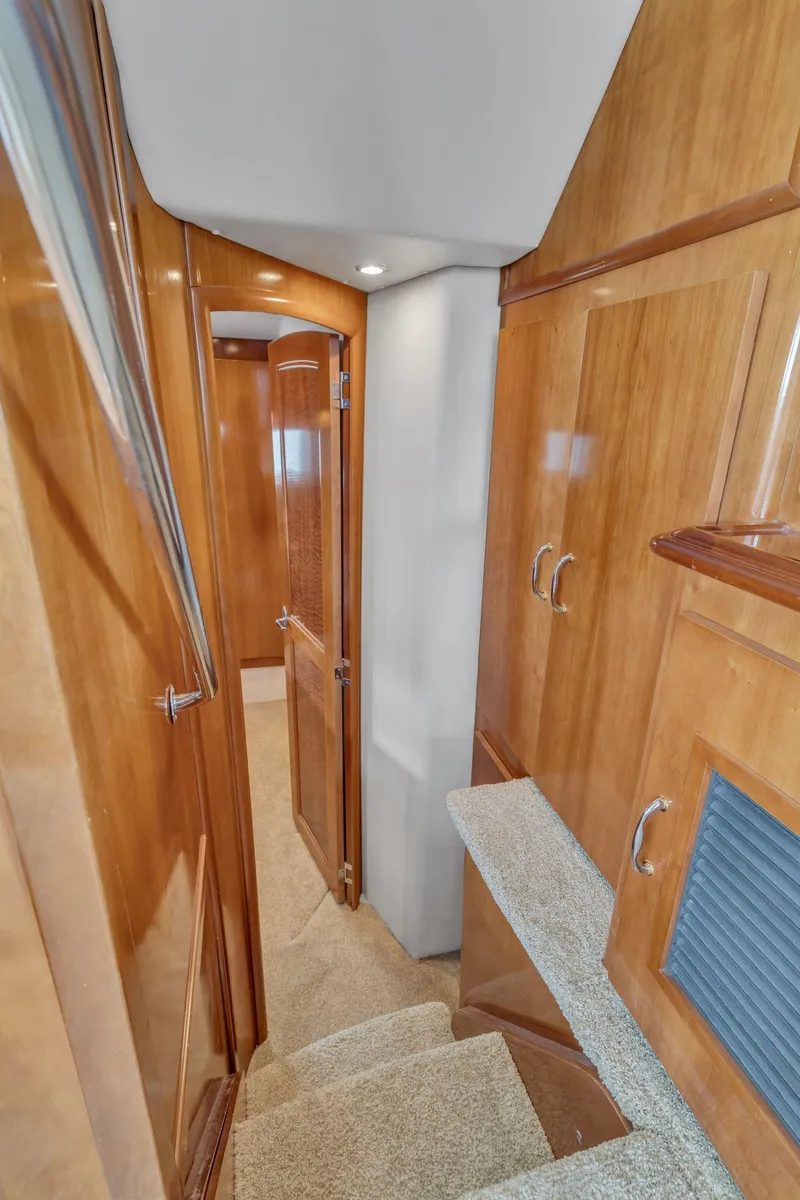 Slide: The Image of Interior hallway of 2004 Carver 466 Motor Yacht with wooden cabinetry and carpeted stairs. - 45