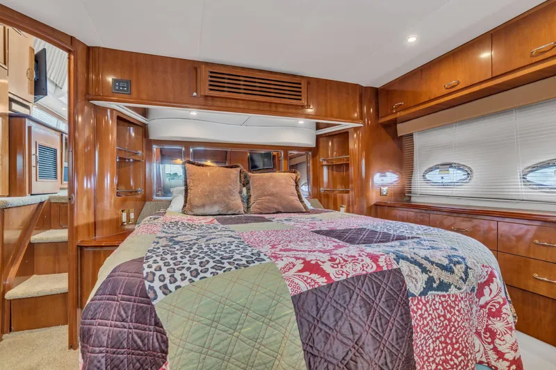 Slide: The Image of Luxurious bedroom interior of 2004 Carver 466 Motor Yacht with colorful quilt and wood paneling. - 47