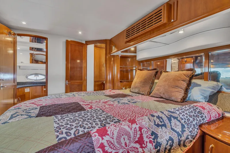 Slide: The Image of Luxurious bedroom interior of 2004 Carver 466 Motor Yacht with colorful bedding. - 49