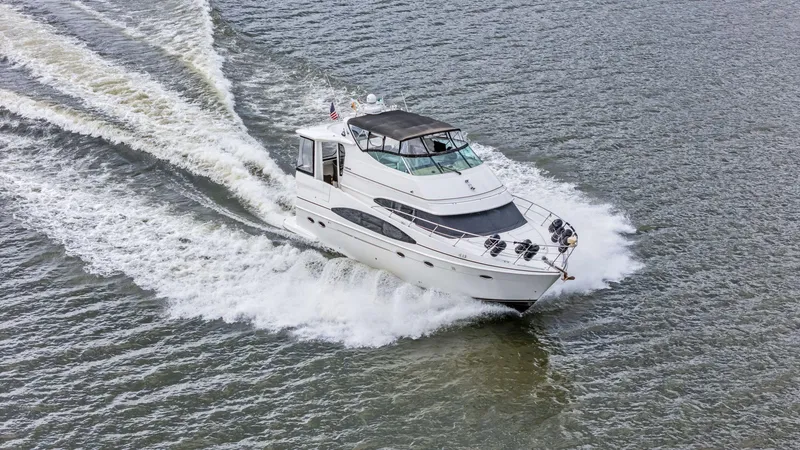 Slide: The Image of 2004 Carver 466 Motor Yacht cruising on open water. - 5