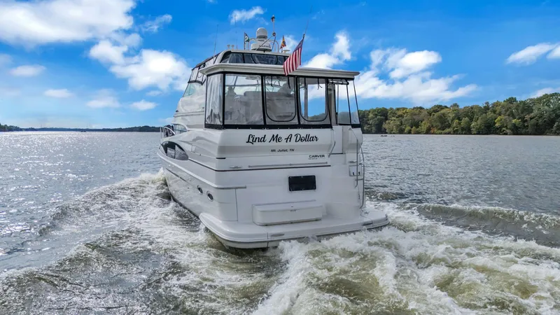 Slide: The Image of 2004 Carver 466 Motor Yacht cruising on a scenic river. - 7