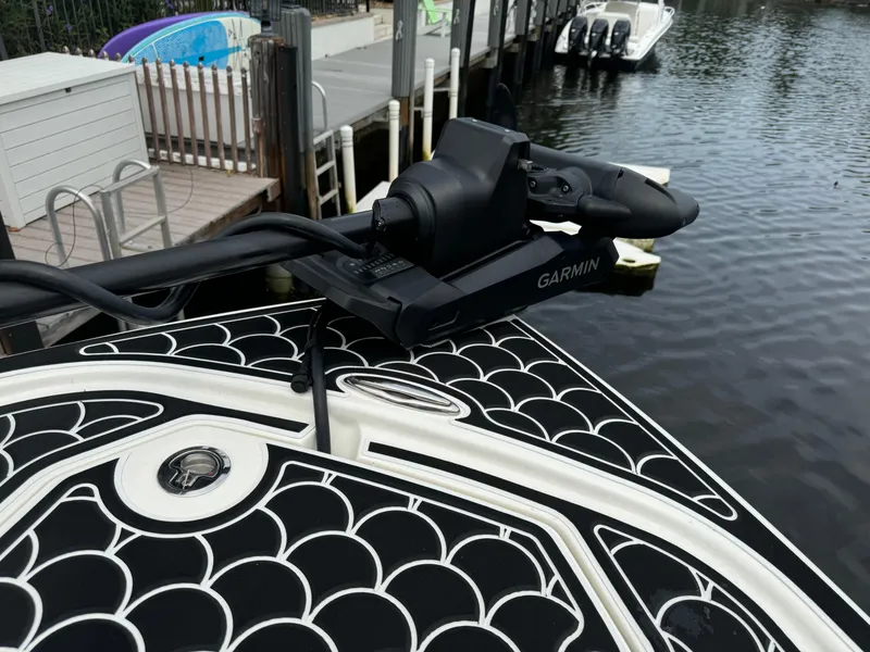 Slide: The Image of 2024 Pathfinder 2500 Hybrid boat with Garmin equipment on deck by the dock. - 14