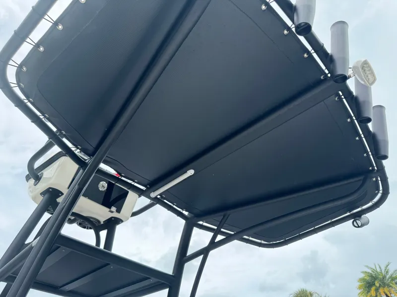 Slide: The Image of 2024 Pathfinder 2500 Hybrid boat T-top with rod holders and equipment. - 16