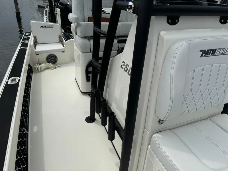 Slide: The Image of 2024 Pathfinder 2500 Hybrid boat interior with white seating and sleek design. - 22