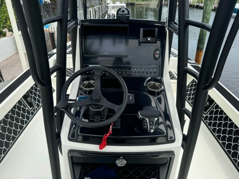 Slide: The Image of 2024 Pathfinder 2500 Hybrid boat console with steering wheel and controls. - 23