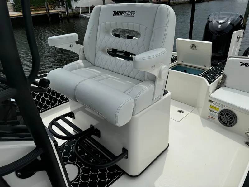 Slide: The Image of 2024 Pathfinder 2500 Hybrid boat seat with armrests and footrests, dockside view. - 27