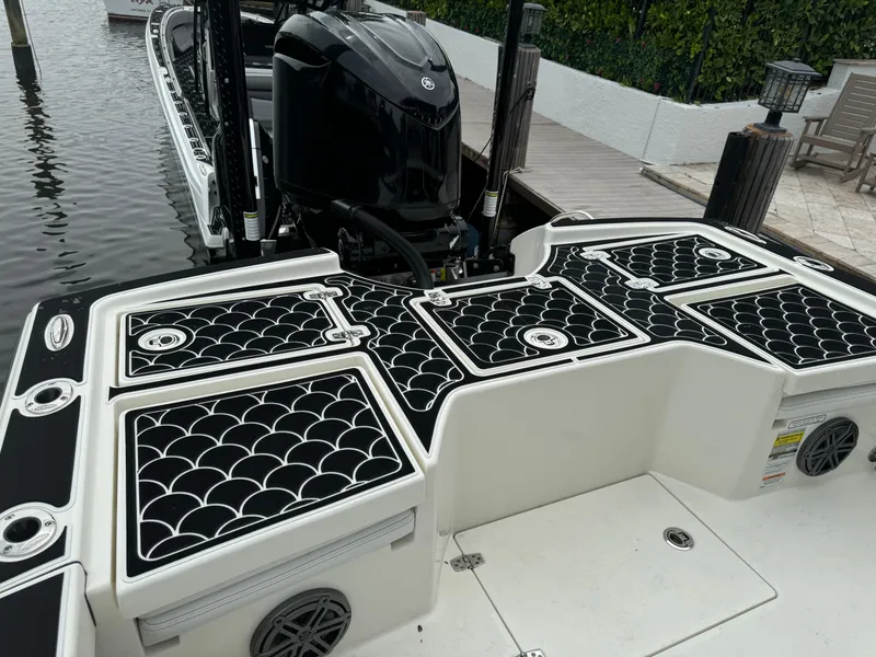 Slide: The Image of 2024 Pathfinder 2500 Hybrid boat with stylish deck design and powerful outboard motor. - 29