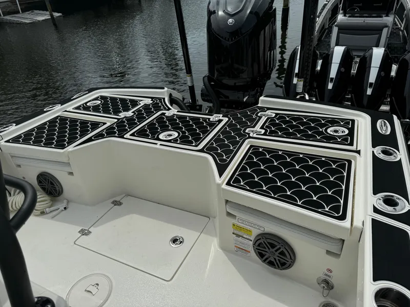 Slide: The Image of 2024 Pathfinder 2500 Hybrid boat deck with black non-slip mats and storage compartments. - 31
