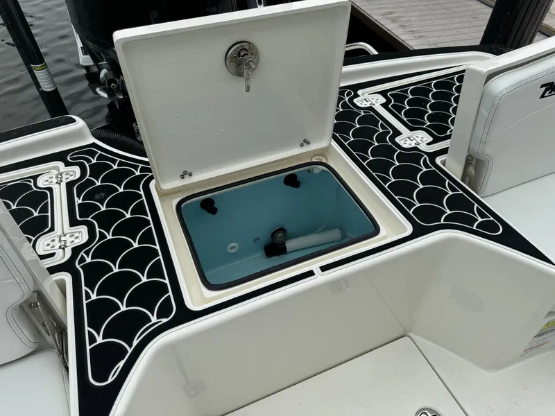 Slide: The Image of 2024 Pathfinder 2500 Hybrid boat with open storage compartment and stylish deck design. - 33