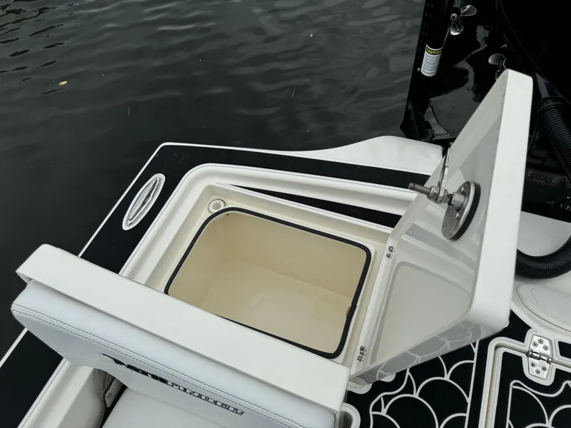 Slide: The Image of Open storage compartment on 2024 Pathfinder 2500 Hybrid boat by the water. - 35