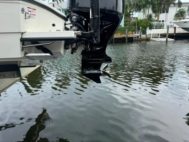 Slide: The Image of 2024 Pathfinder 2500 Hybrid boat engine over water, dockside view. - 38