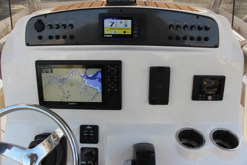 Slide: The Image of Dashboard of 2020 Pioneer 222 Sportfish boat with navigation and control systems. - 12