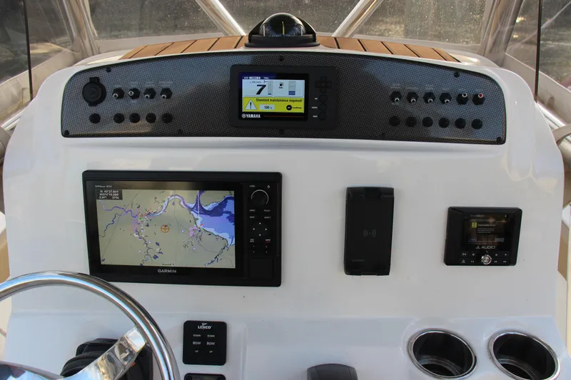 Slide: The Image of 2020 Pioneer 222 Sportfish dashboard with navigation and control systems. - 13