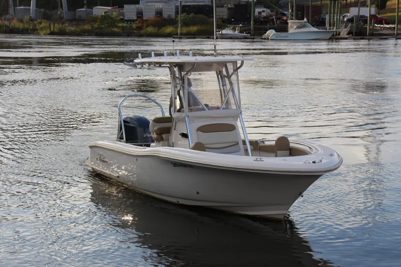 Slide: The Image of 2020 Pioneer 222 Sportfish boat on calm water, featuring sleek design and modern amenities. - 3