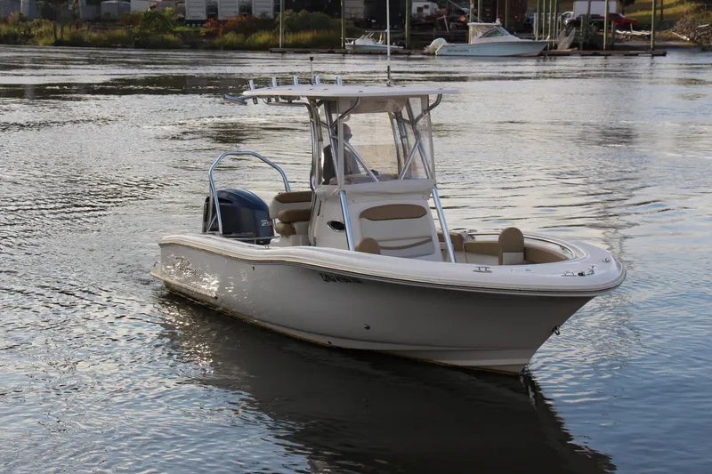 Slide: The Image of 2020 Pioneer 222 Sportfish boat on calm water, featuring sleek design and modern amenities. - 4