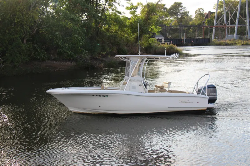 Slide: The Image of 2020 Pioneer 222 Sportfish boat on a calm river. - 5