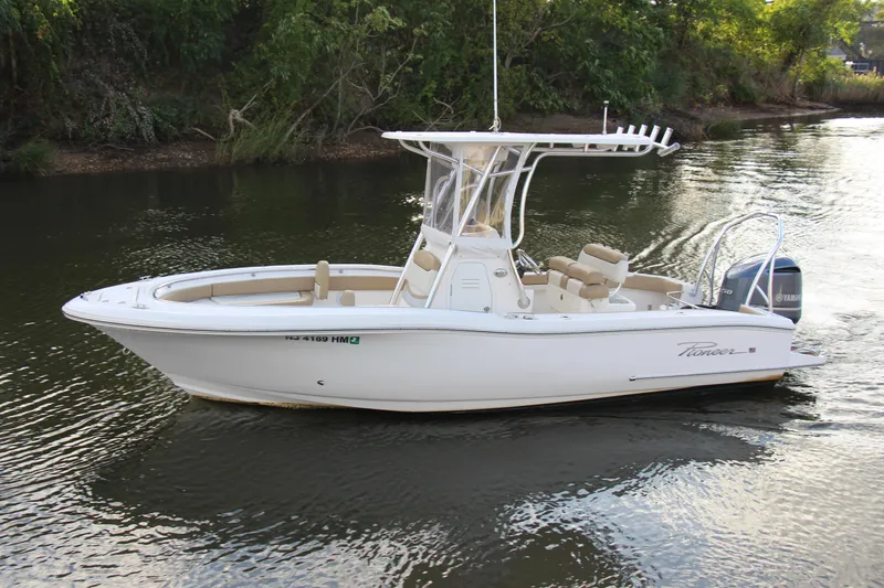 Slide: The Image of 2020 Pioneer 222 Sportfish boat cruising on a calm river. - 6