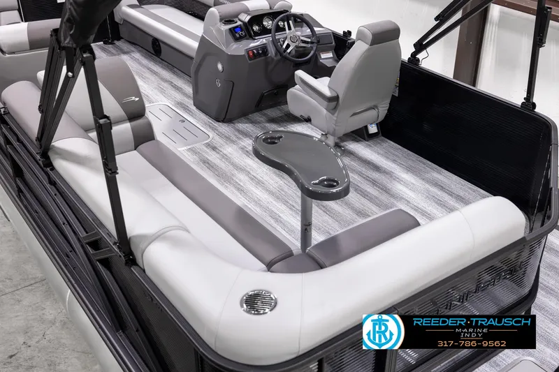 Slide: The Image of 2025 Bennington 21 SL pontoon boat interior with gray seating and modern dashboard. - 10