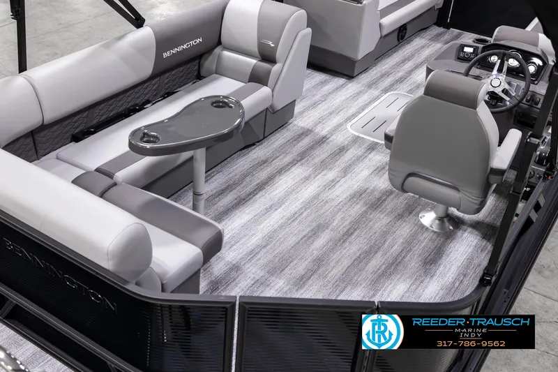 Slide: The Image of 2025 Bennington 21 SL pontoon boat interior with gray seating and steering console. - 11