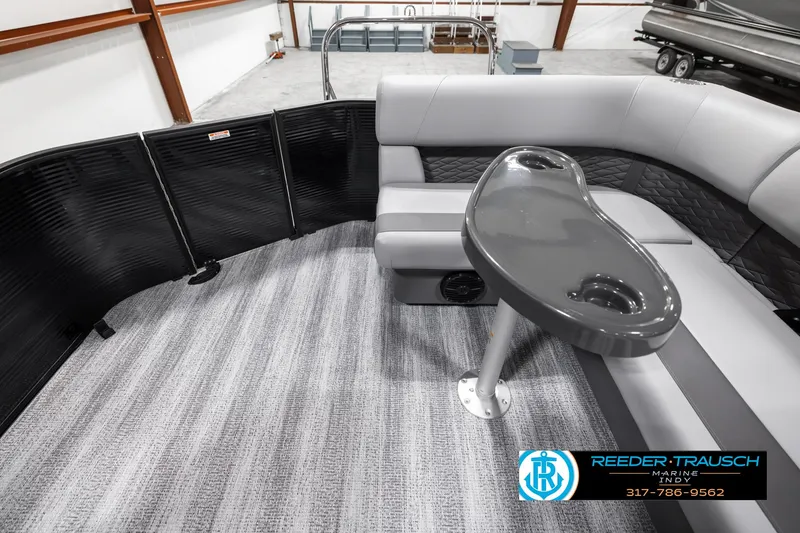 Slide: The Image of 2025 Bennington 21 SL pontoon boat interior with gray seating and table. - 16