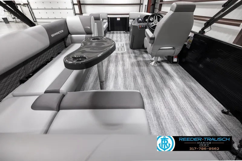 Slide: The Image of 2025 Bennington 21 SL pontoon boat interior with gray seating and modern helm. - 17