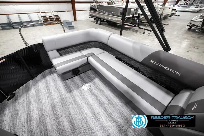 Slide: The Image of 2025 Bennington 21 SL pontoon boat interior with gray seating in showroom. - 23