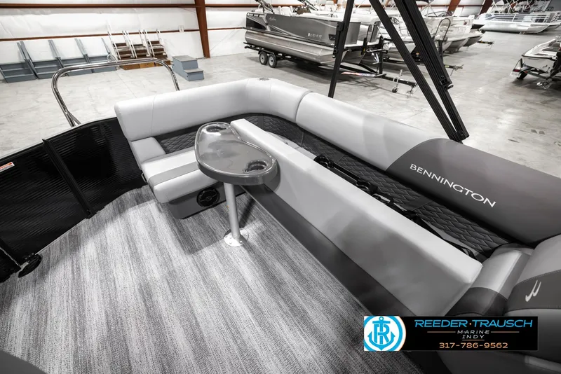 Slide: The Image of 2025 Bennington 21 SL pontoon boat interior with gray seating and table. - 24
