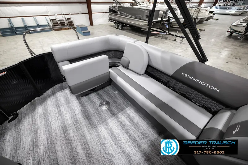 Slide: The Image of 2025 Bennington 21 SL pontoon boat interior with gray seating and carpet flooring. - 25