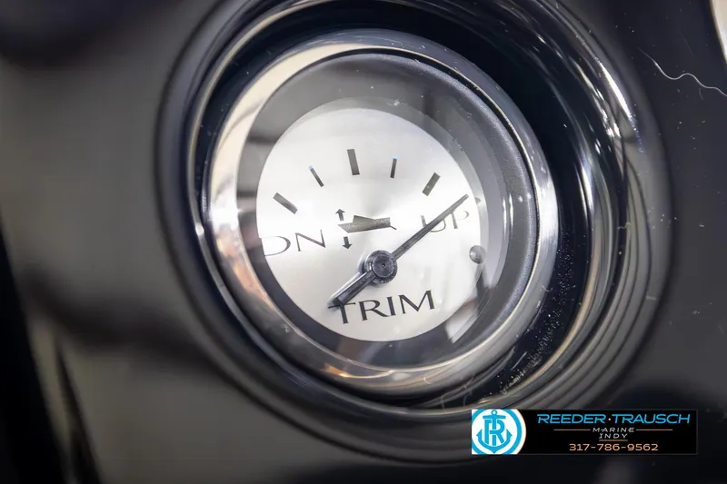 Slide: The Image of Close-up of 2025 Bennington 21 SL trim gauge with Reeder-Trausch Marine logo. - 31
