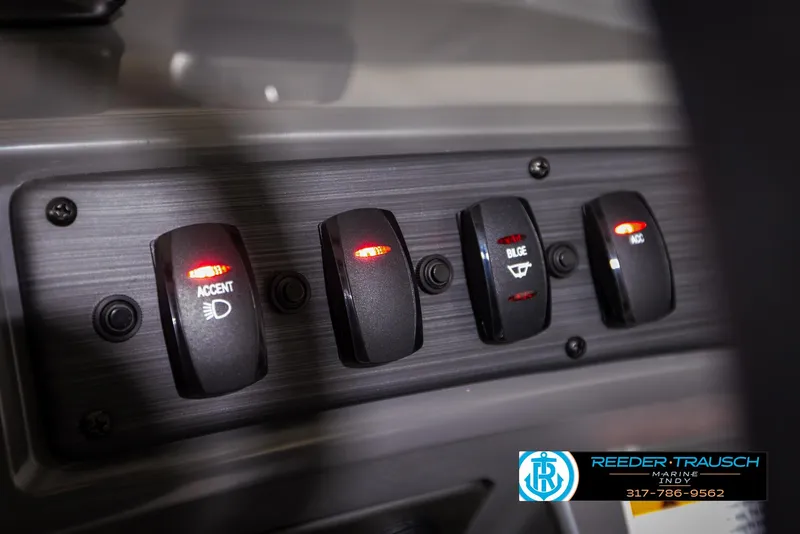Slide: The Image of Control panel of 2025 Bennington 21 SL boat with illuminated switches. - 34