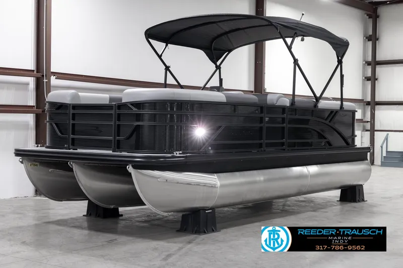 Slide: The Image of 2025 Bennington 21 SL pontoon boat with canopy in a showroom. - 4