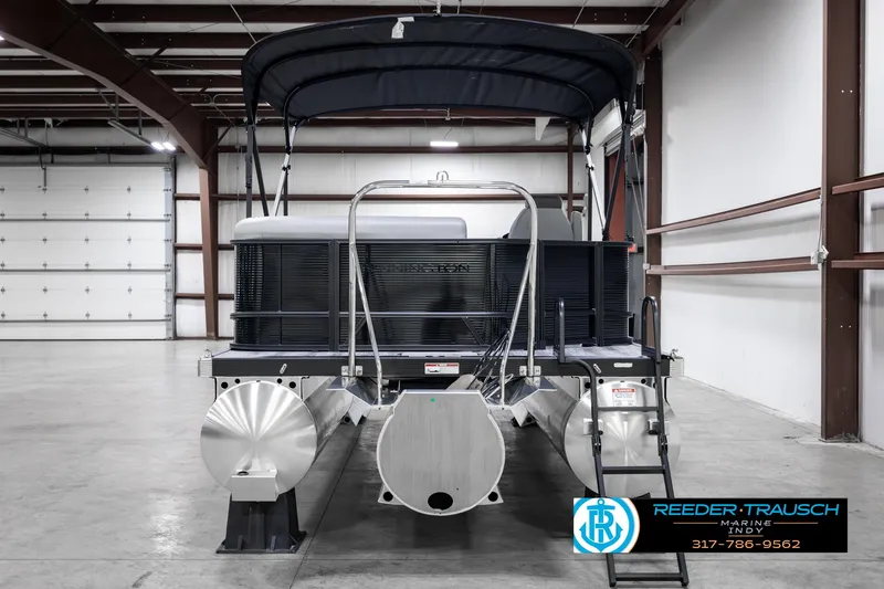 Slide: The Image of 2025 Bennington 21 SL pontoon boat in warehouse, rear view with canopy. - 7