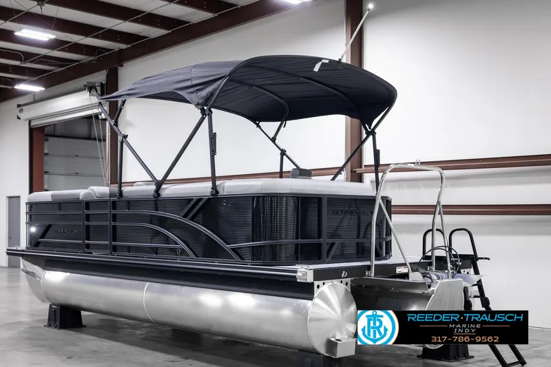 Slide: The Image of 2025 Bennington 21 SL pontoon boat in showroom with canopy and sleek design. - 8