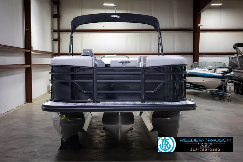 Slide: The Image of 2025 Bennington 21 SL pontoon boat in indoor showroom. - 9