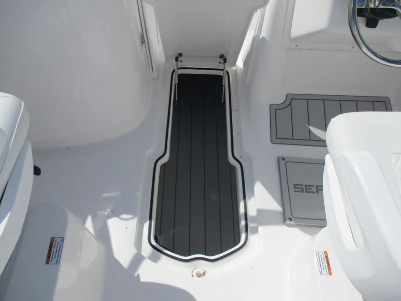 Slide: The Image of Interior of 2025 Sea Fox 228 Traveler boat, featuring sleek flooring and seating. - 13