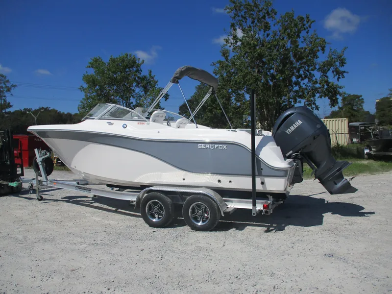 Slide: The Image of 2025 Sea Fox 228 Traveler boat on trailer, parked outdoors. - 4