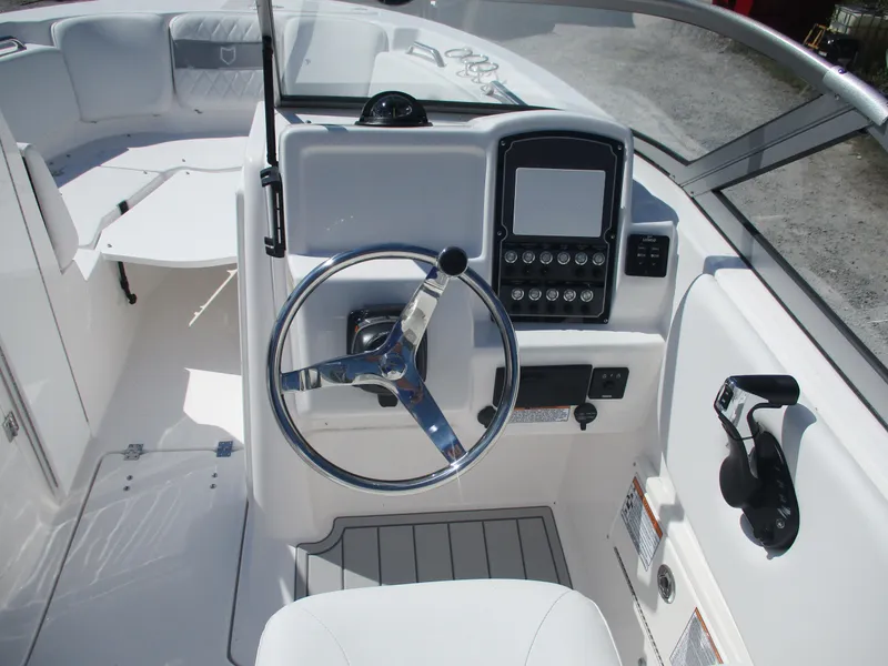 Slide: The Image of 2025 Sea Fox 228 Traveler boat cockpit with steering wheel and control panel. - 6
