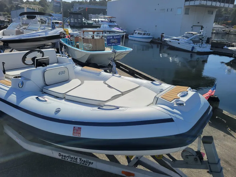 Slide: The Image of 2021 AB Inflatables ABJET 430XP boat on trailer at marina. - 13